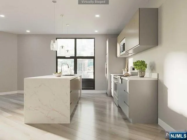 a view of kitchen with furniture and wooden floor