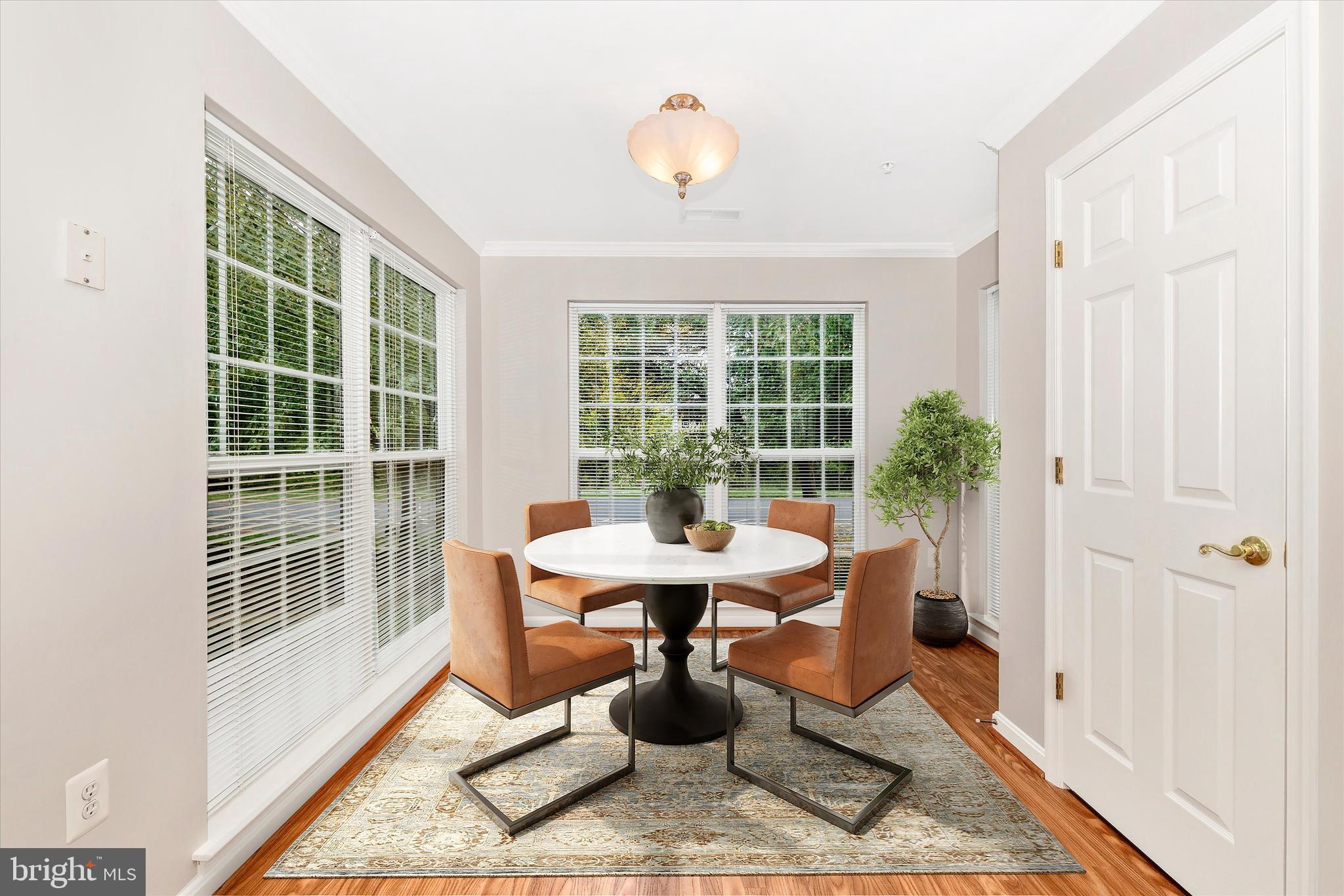 2508 Shelley Circle, Unit 8 1A Frederick, MD 21702 - Photo 8 of 48 a dining room with wooden floor and a chandelier