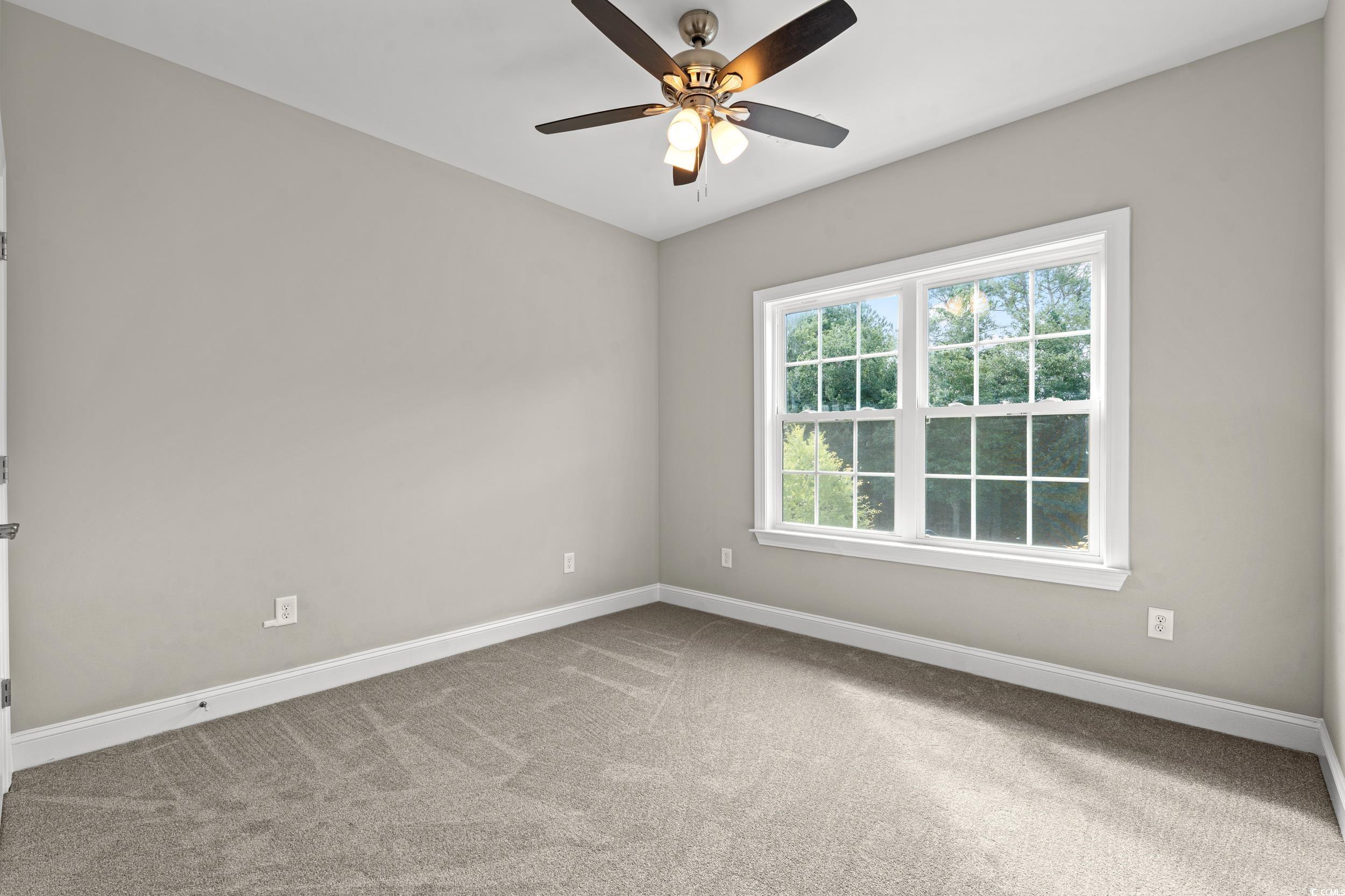 344 Kiskadee Loop, Unit E Conway, SC 29526 - Photo 17 of 36 Unfurnished room with ceiling fan and carpet