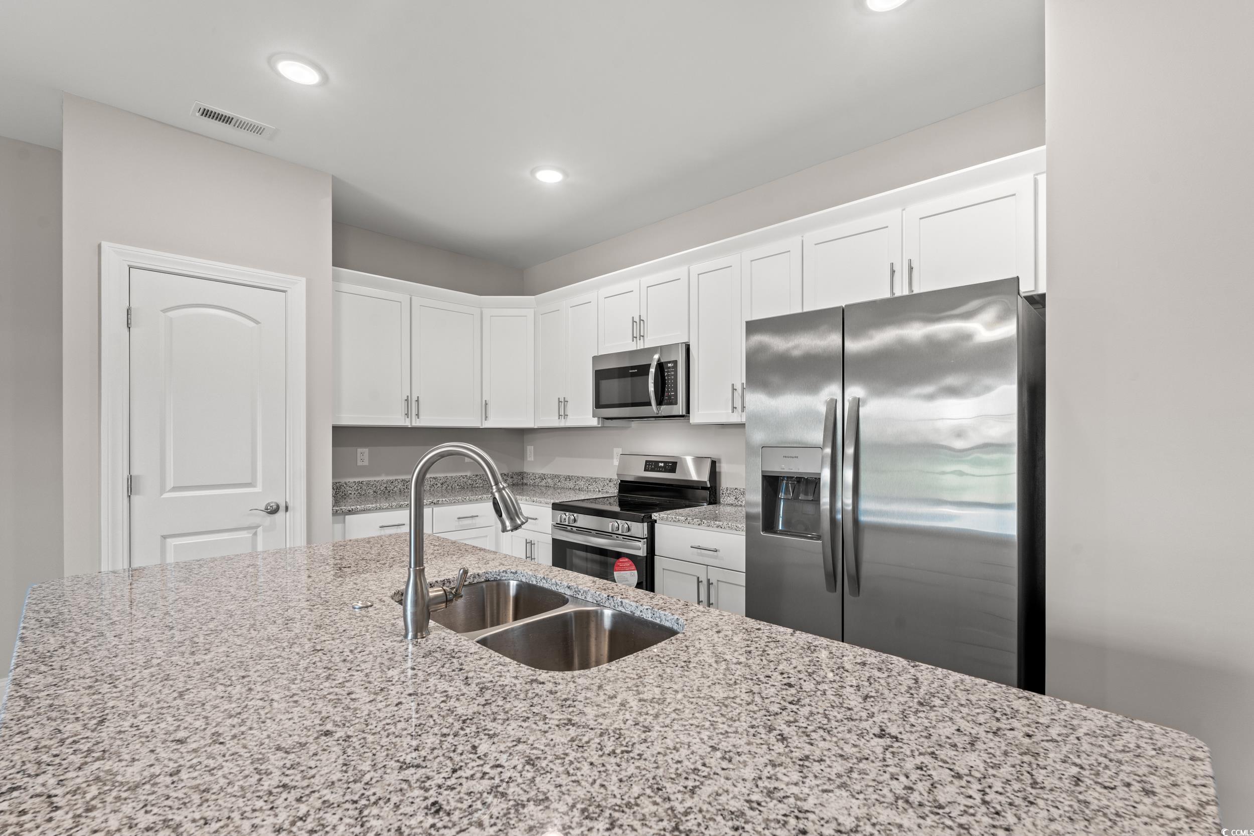 344 Kiskadee Loop, Unit E Conway, SC 29526 - Photo 6 of 36 Kitchen with sink, stainless steel appliances, whi