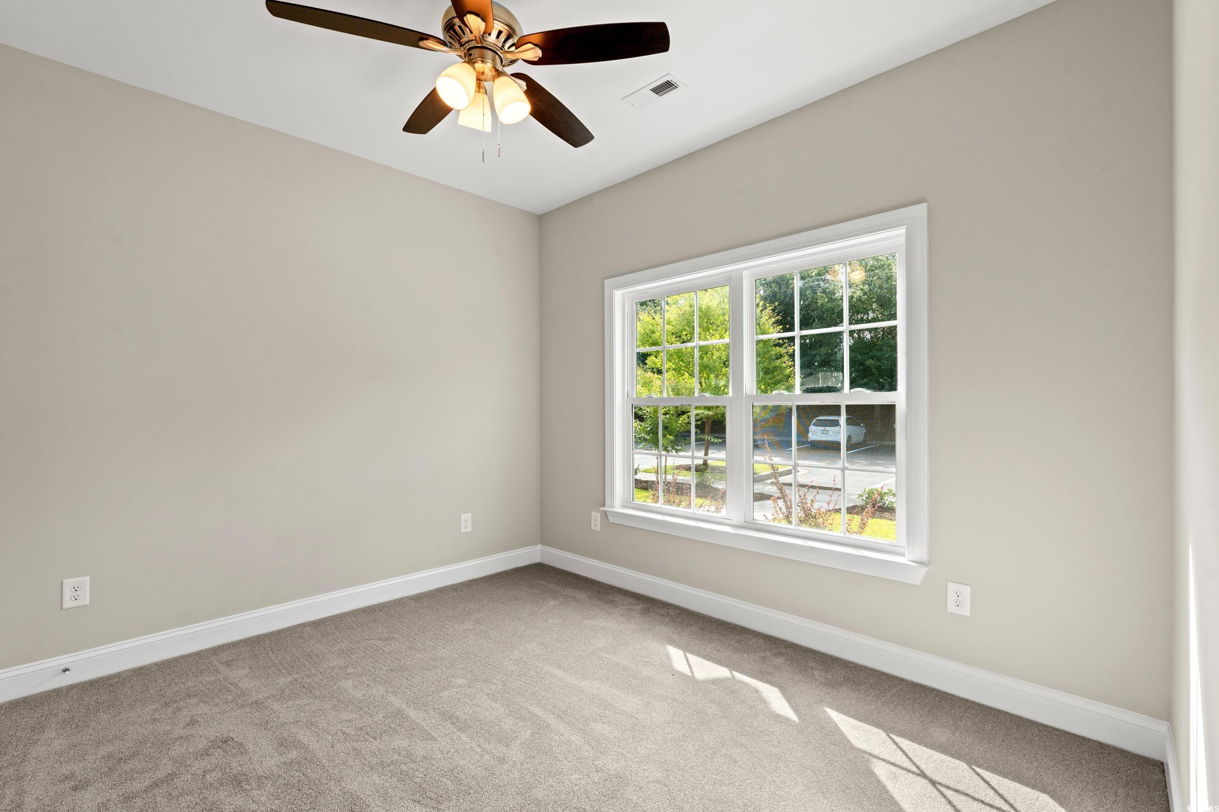 344 Kiskadee Loop, Unit E Conway, SC 29526 - Photo 7 of 36 Carpeted empty room featuring ceiling fan