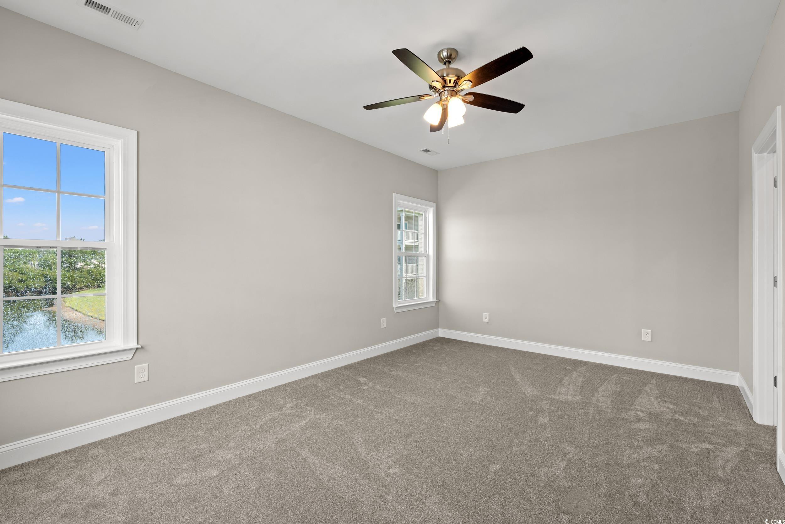 344 Kiskadee Loop, Unit E Conway, SC 29526 - Photo 10 of 36 Empty room with a wealth of natural light, carpet