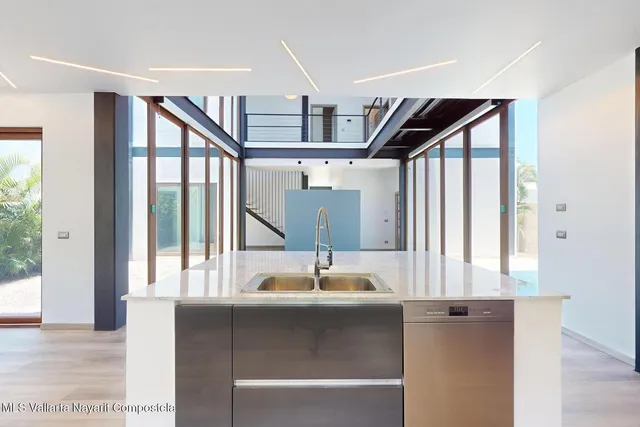 a view of empty room with wooden floor and floor to ceiling window