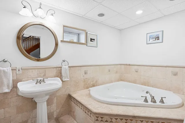 a bathroom with a bathtub and a sink