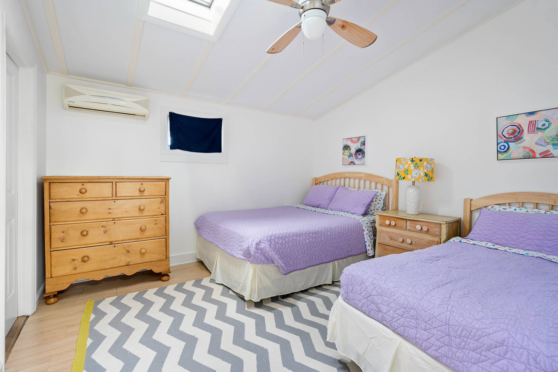 5 South Dorset Drive Montauk, NY 11954 - Photo 18 of 20 a bedroom with two beds and painting on the wall