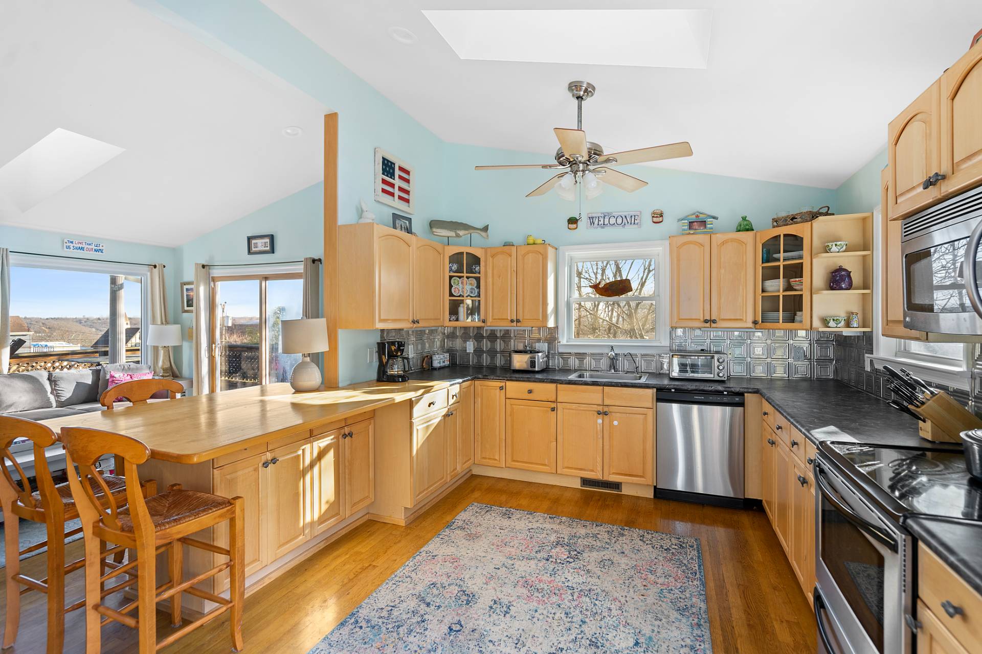 5 South Dorset Drive Montauk, NY 11954 - Photo 3 of 20 a large white kitchen with stainless steel appliances granite countertop a stove and a sink