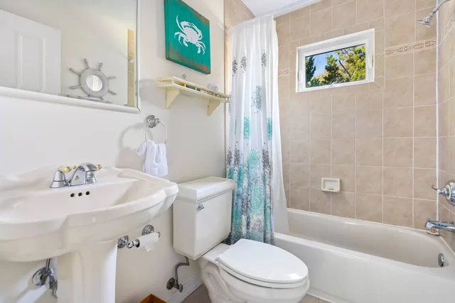 a white toilet sitting next to a bathroom sink
