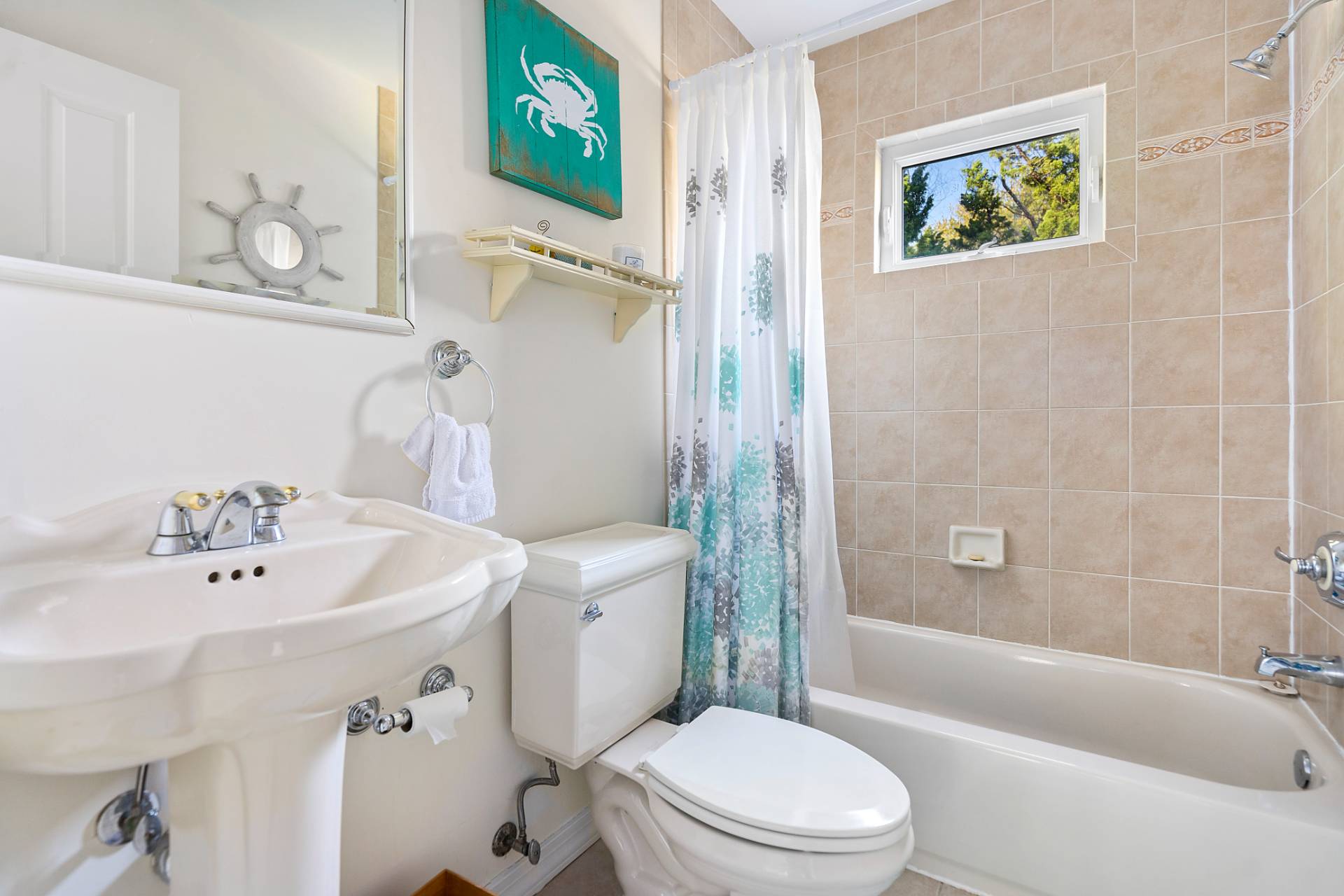 5 South Dorset Drive Montauk, NY 11954 - Photo 8 of 20 a white toilet sitting next to a bathroom sink