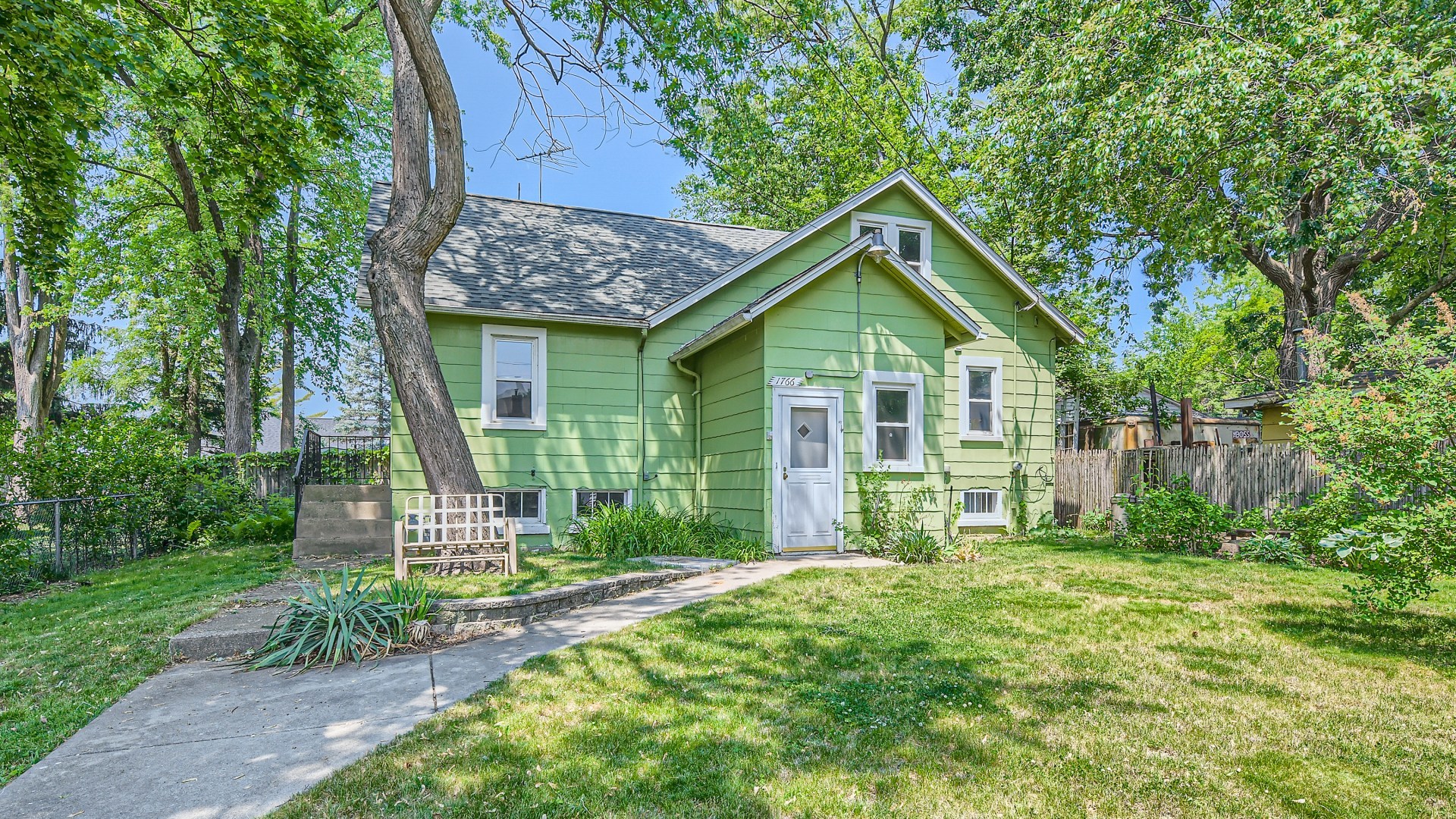 a view of a house with a yard and garden