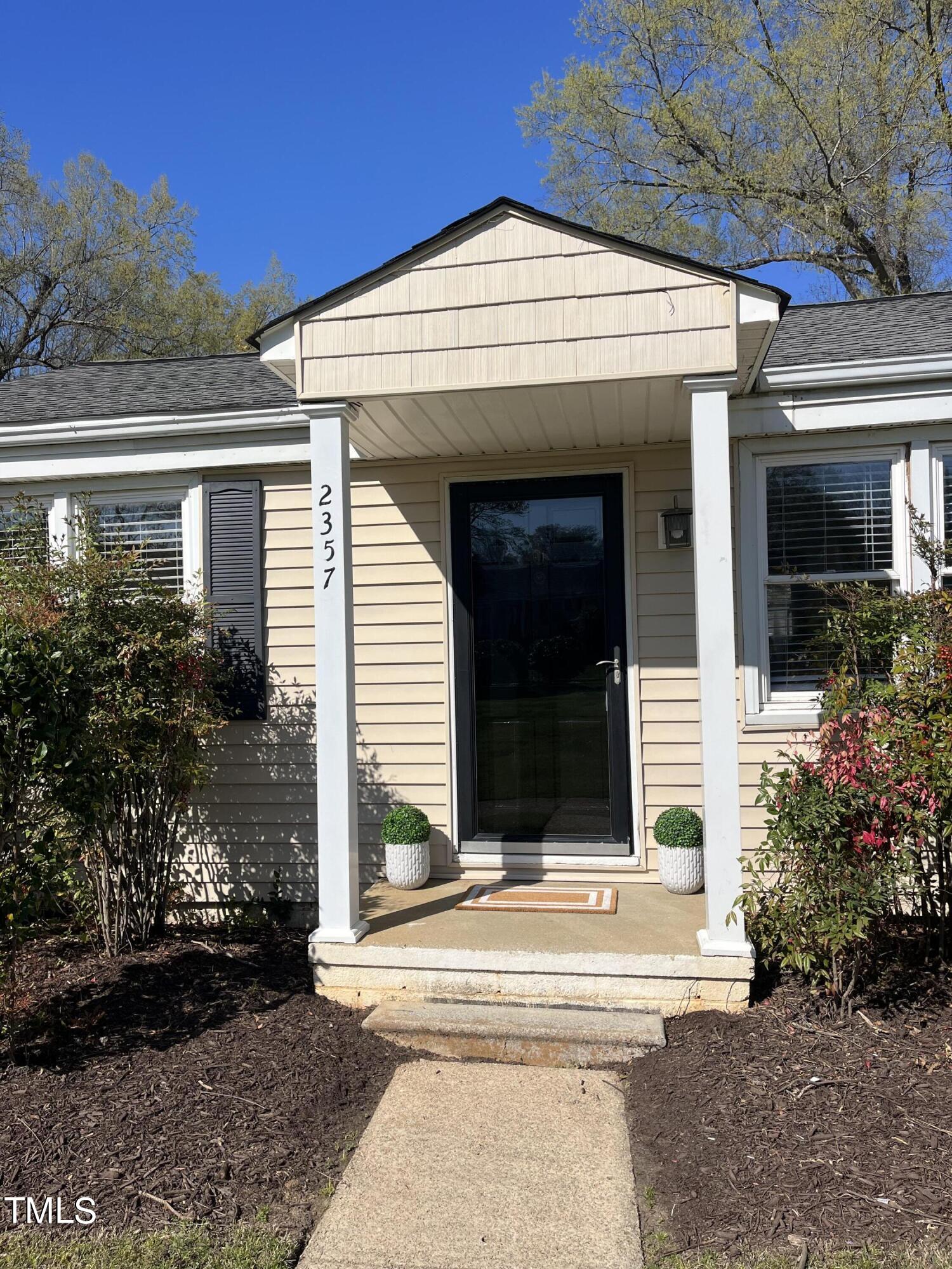 2357 Bernard Street Raleigh, NC 27608 - Photo 1 of 14 a front view of a house with garden