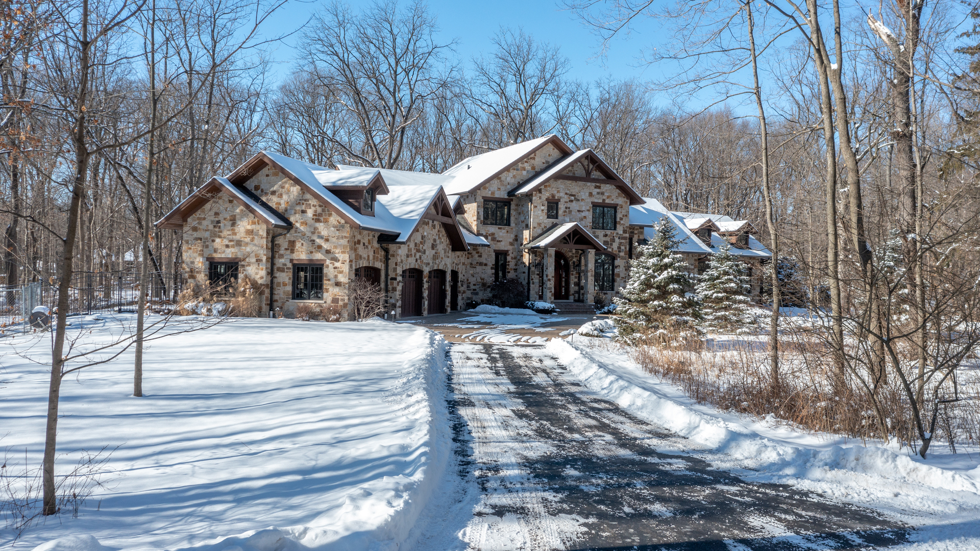 a view of a house with a yard covered in snow