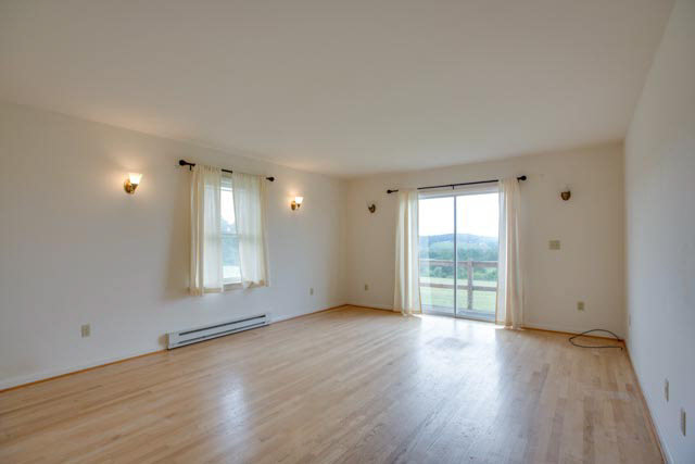 984 Ridge Road Bridgewater, VA 22812 - Photo 6 of 29 an empty room with wooden floor and windows