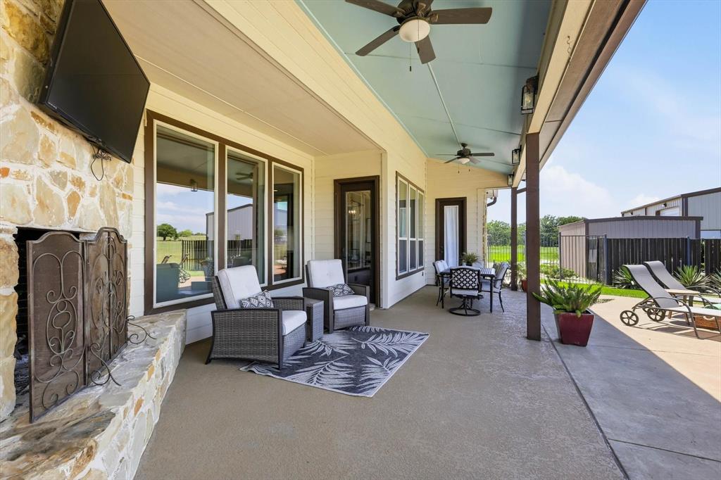 4920 Peden Road Fort Worth, TX 76179 - Photo 25 of 40 Large Covered Patio with Outdoor Gas Fireplace and Large Amount of Seating.