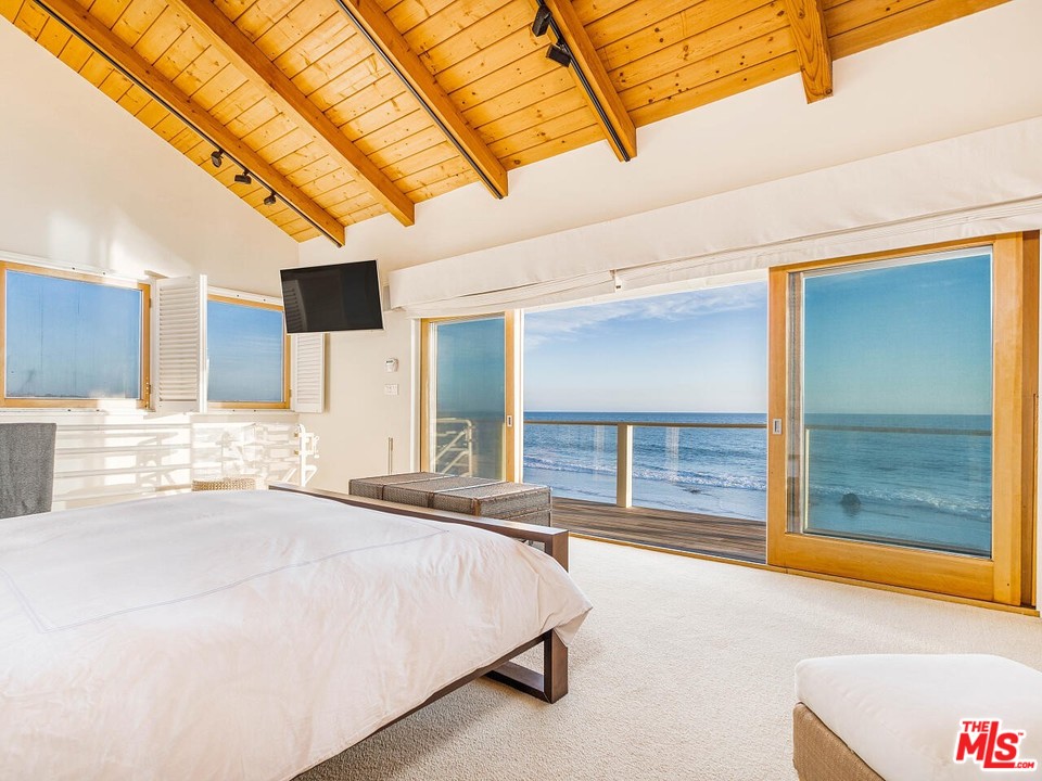 31376 Broad Beach Road Malibu, CA 90265 - Photo 2 of 26 a spacious bedroom with a large bed and a large window