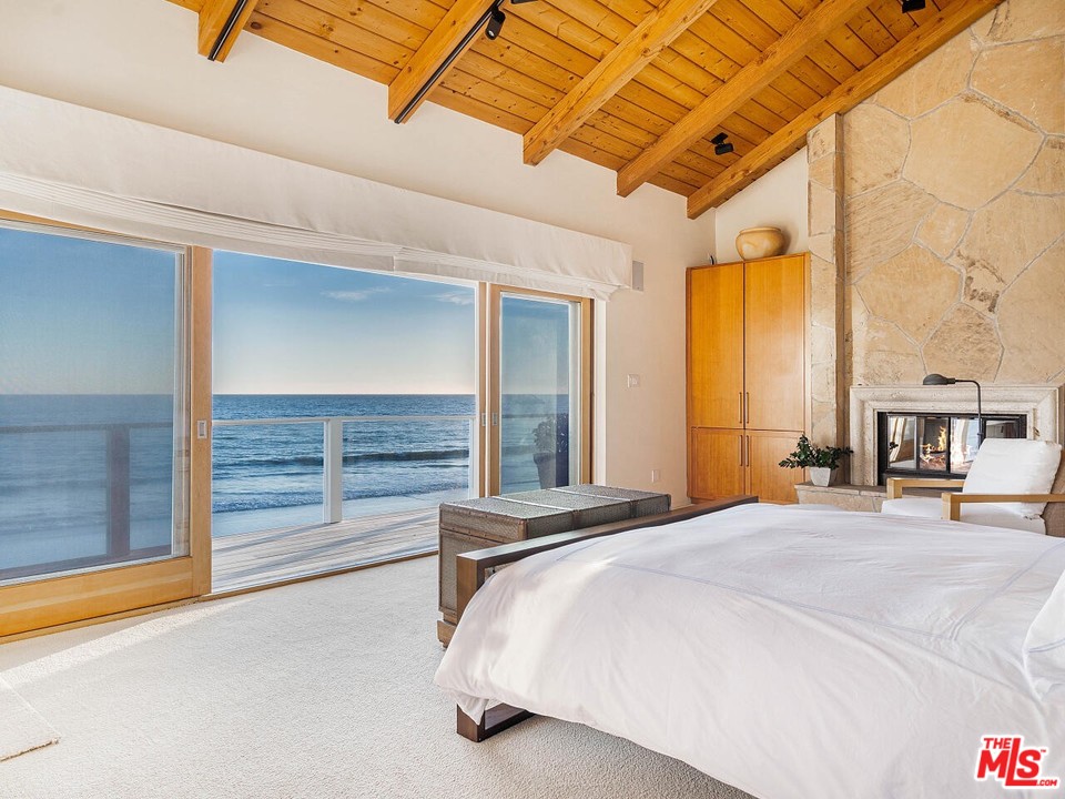 31376 Broad Beach Road Malibu, CA 90265 - Photo 3 of 26 a bed sitting in a spacious bedroom next to a window