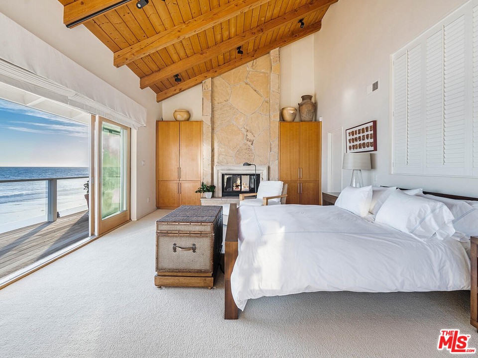 31376 Broad Beach Road Malibu, CA 90265 - Photo 4 of 26 a bedroom with a bed next to a large window with the outer view