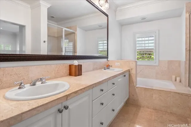 a bathroom with double vanity sinks and a bathtub
