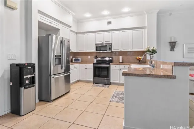 a kitchen with stainless steel appliances granite countertop a refrigerator sink and microwave