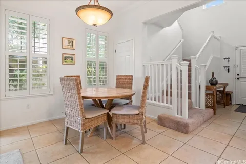a view of a dining room with furniture and a chandelier