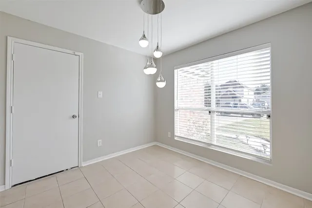 a view of a big room with wooden floor closet and windows