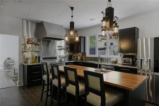 a kitchen with a table chairs refrigerator and microwave