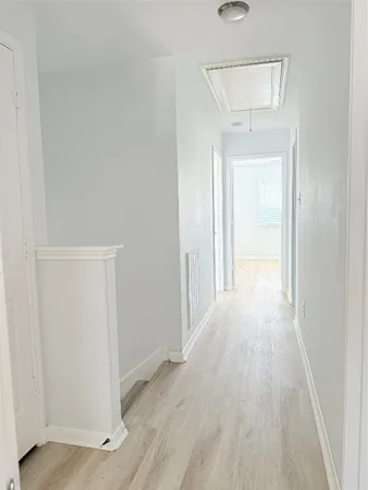 a view of a room with wooden floor