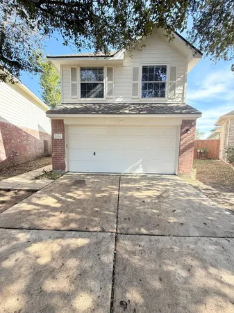 a view of a house with a wooden fence