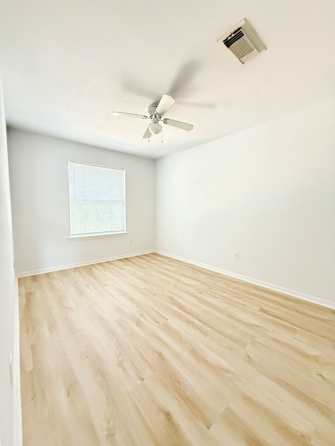 6810 Strathmore Pl Court Katy, TX 77449 - Photo 7 of 14 an empty room with a windows and ceiling fan