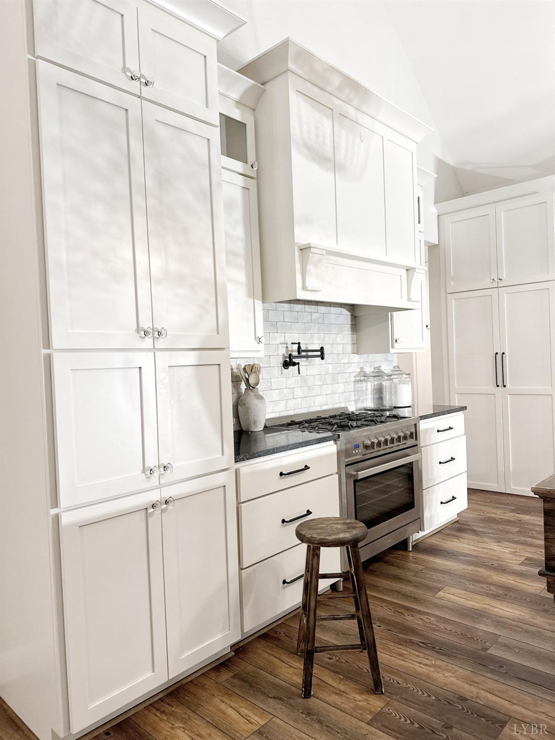 4969 Otterville Road Goode, VA 24556 - Photo 23 of 69 a kitchen with granite countertop white cabinets and white appliances