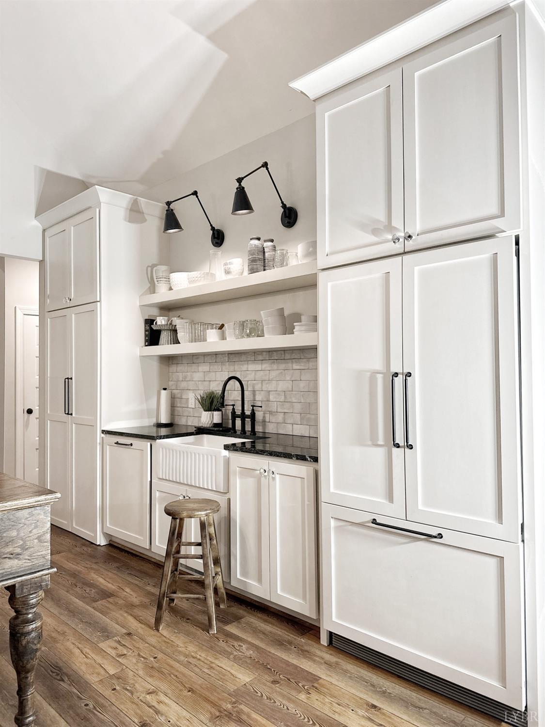 4969 Otterville Road Goode, VA 24556 - Photo 24 of 69 a kitchen with stainless steel appliances a stove and white cabinets