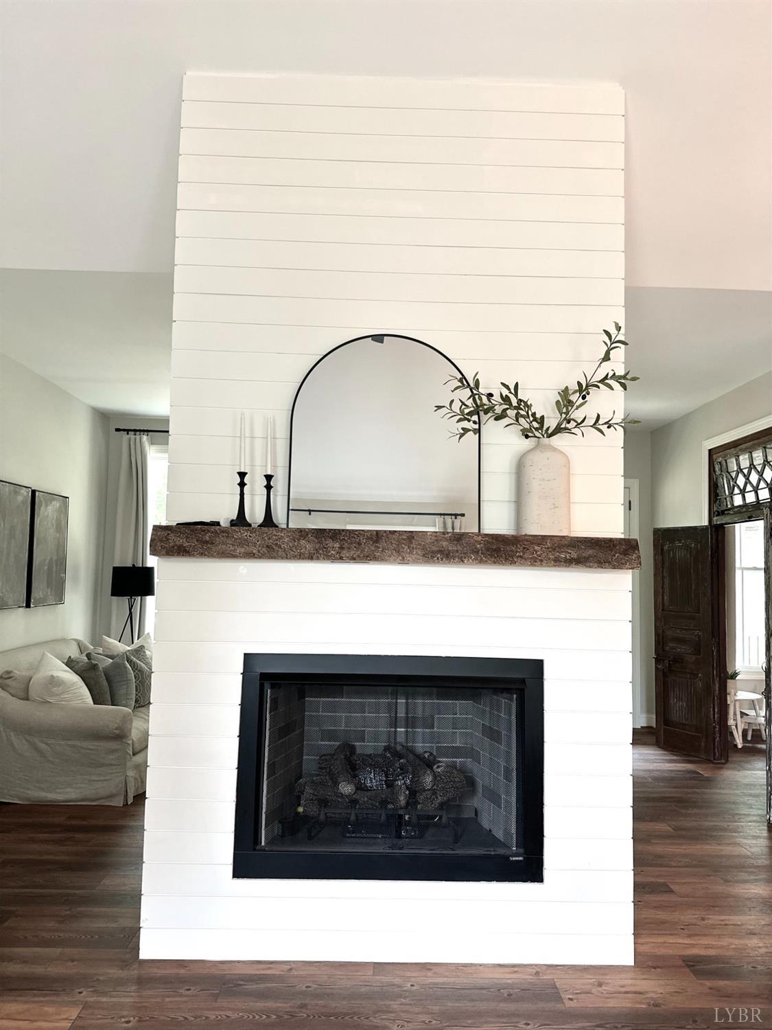 4969 Otterville Road Goode, VA 24556 - Photo 33 of 69 a living room with furniture a fireplace and wooden floor