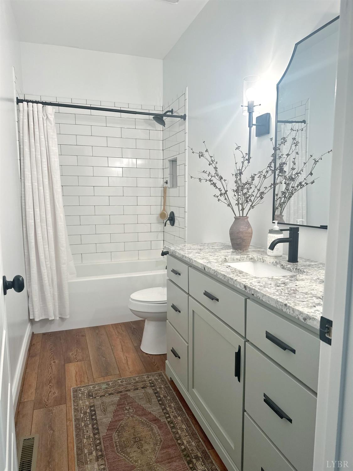 4969 Otterville Road Goode, VA 24556 - Photo 60 of 69 a bathroom with a granite countertop sink toilet and shower
