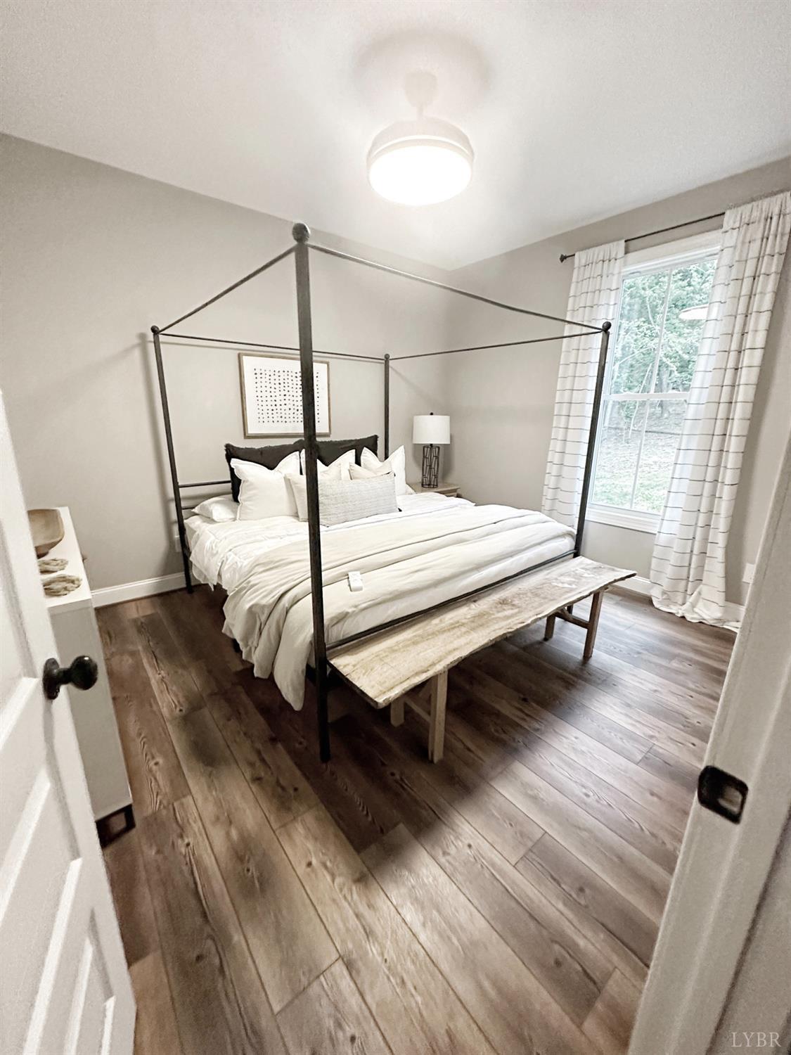 4969 Otterville Road Goode, VA 24556 - Photo 8 of 69 a bedroom with a bed window and wooden floor