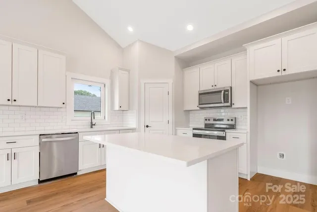 a view of empty room with a fireplace and window