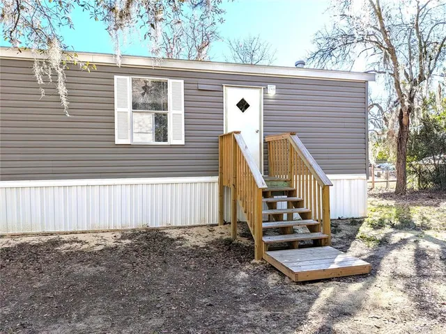 a front view of a house with stairs
