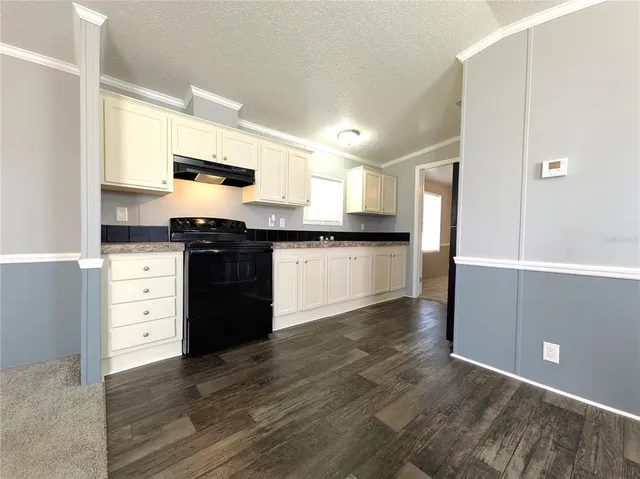 a kitchen with stainless steel appliances granite countertop a stove and a refrigerator
