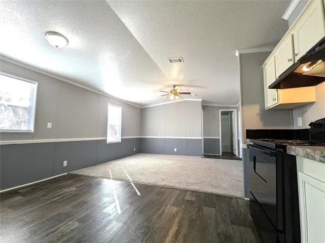 a view of a kitchen with a sink and a stove top oven