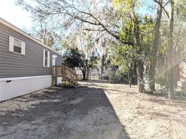 a view of a yard with trees