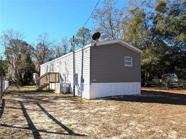 a view of a house with snow on the road