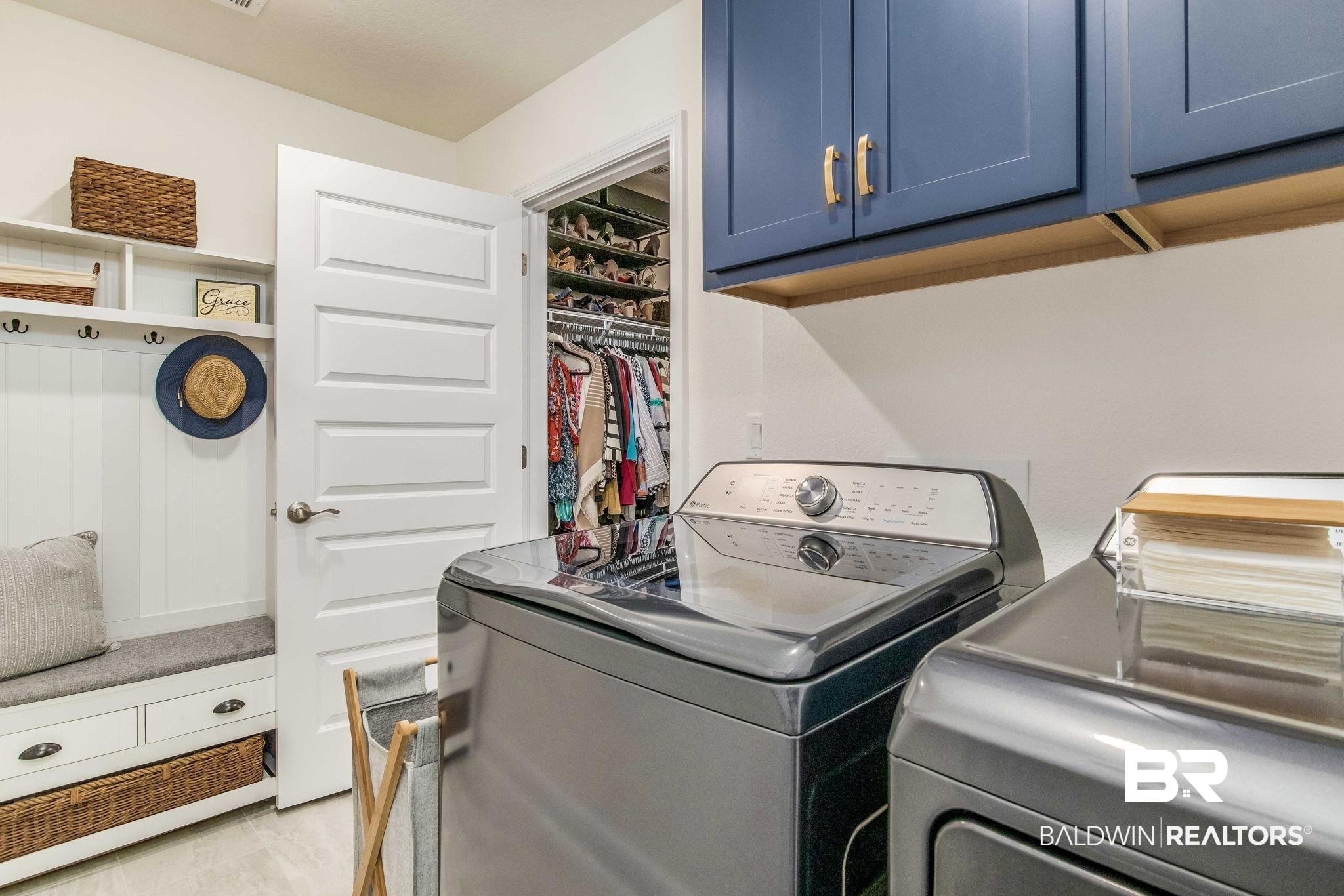 2222 Club House Drive Lillian, AL 36549 - Photo 16 of 49 Laundry area featuring cabinet space and washer and dryer