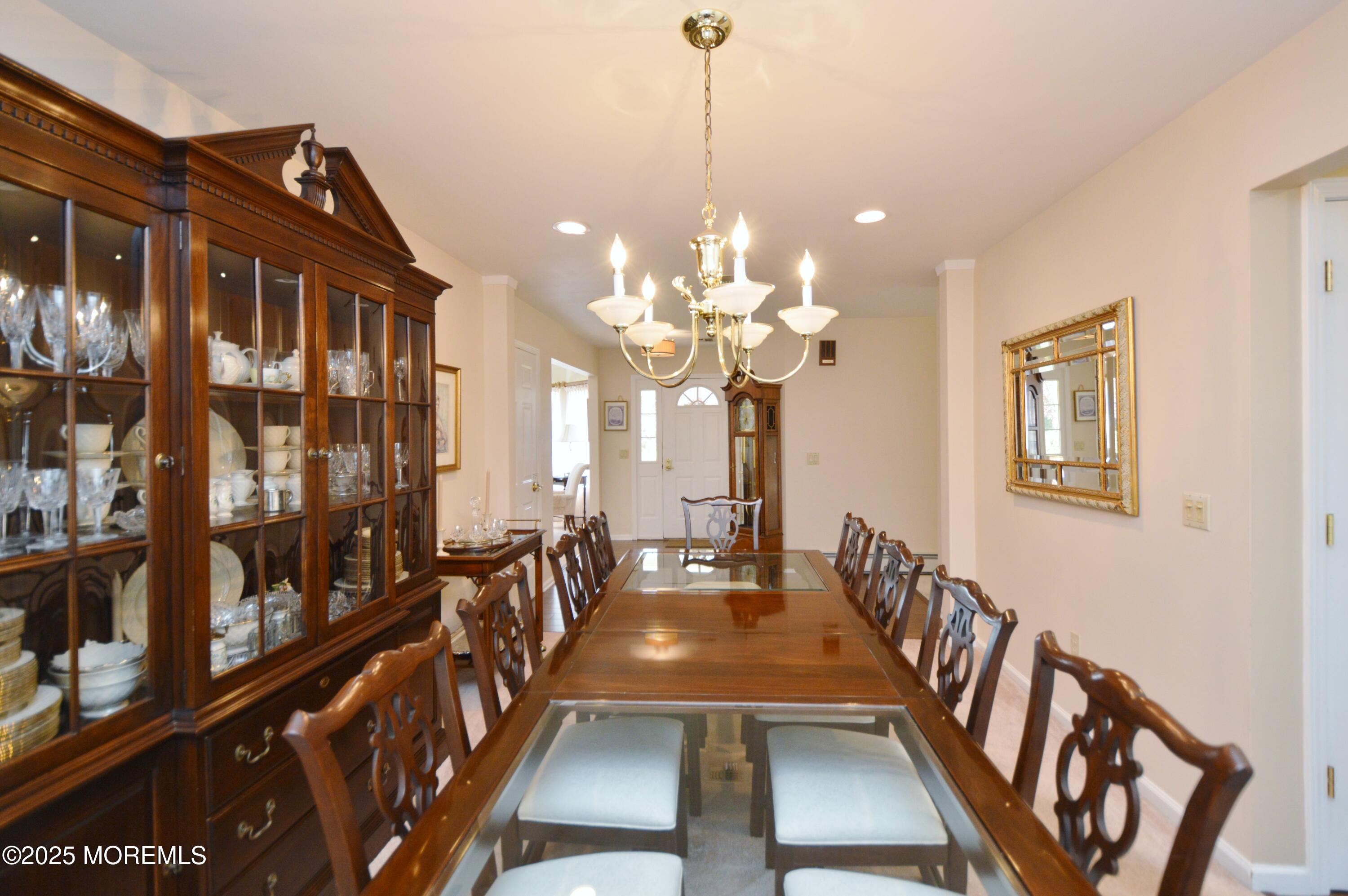 2382 Braddock Road Toms River, NJ 08755 - Photo 14 of 56 a view of a dining room with furniture a chandelier and wooden floor