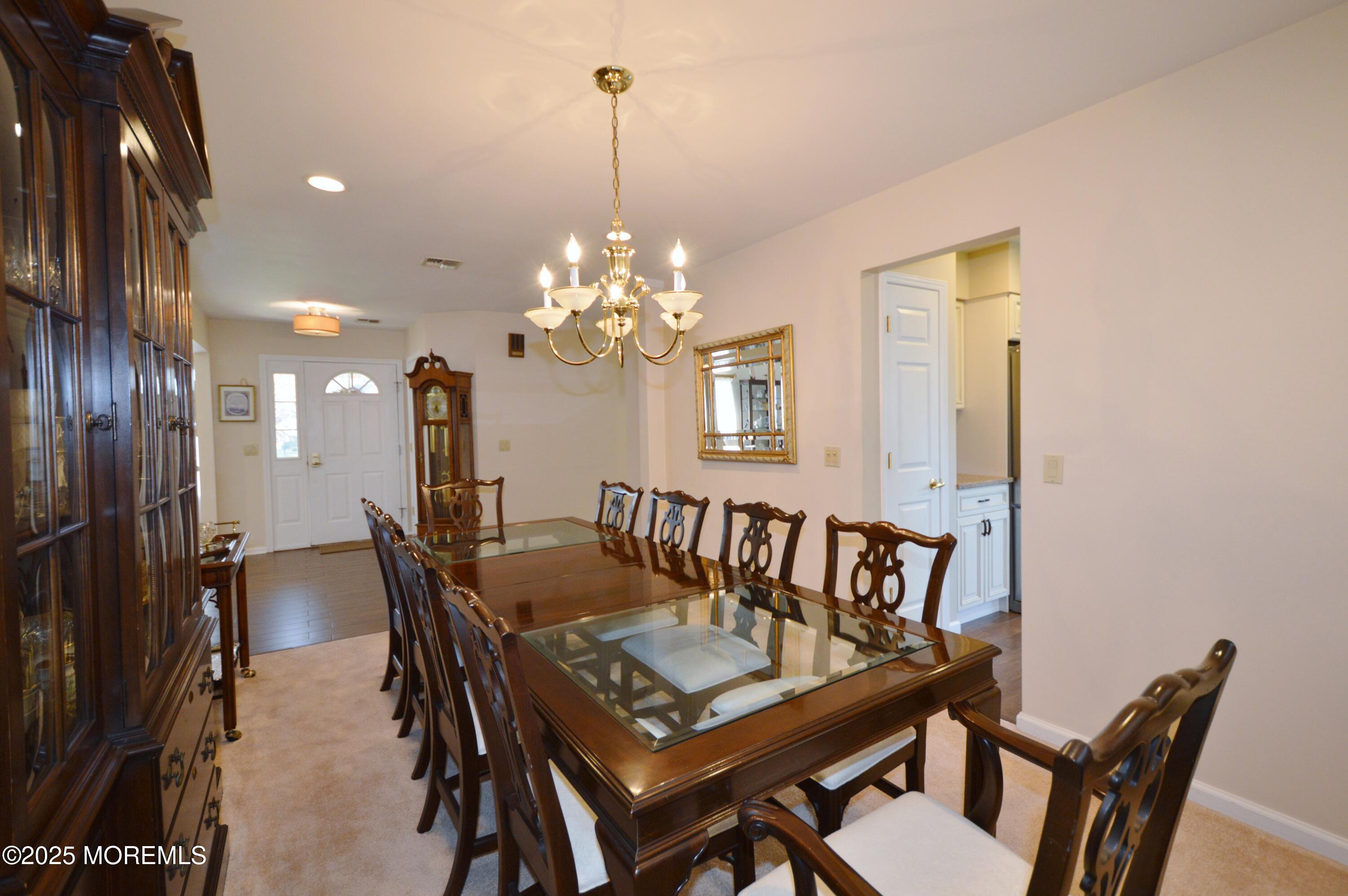 2382 Braddock Road Toms River, NJ 08755 - Photo 15 of 56 a view of a dining room with furniture and chandelier