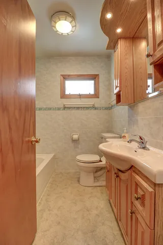 a bathroom with a sink a toilet and mirror