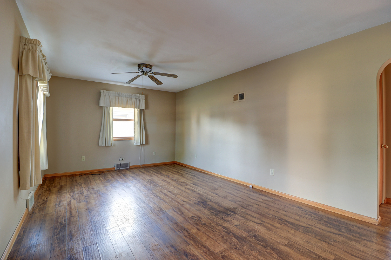 602 East 3rd Street Rock Falls, IL 61071 - Photo 5 of 22 an empty room with wooden floor chandelier fan and windows
