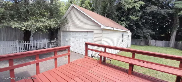 a balcony with wooden floor and outdoor seating
