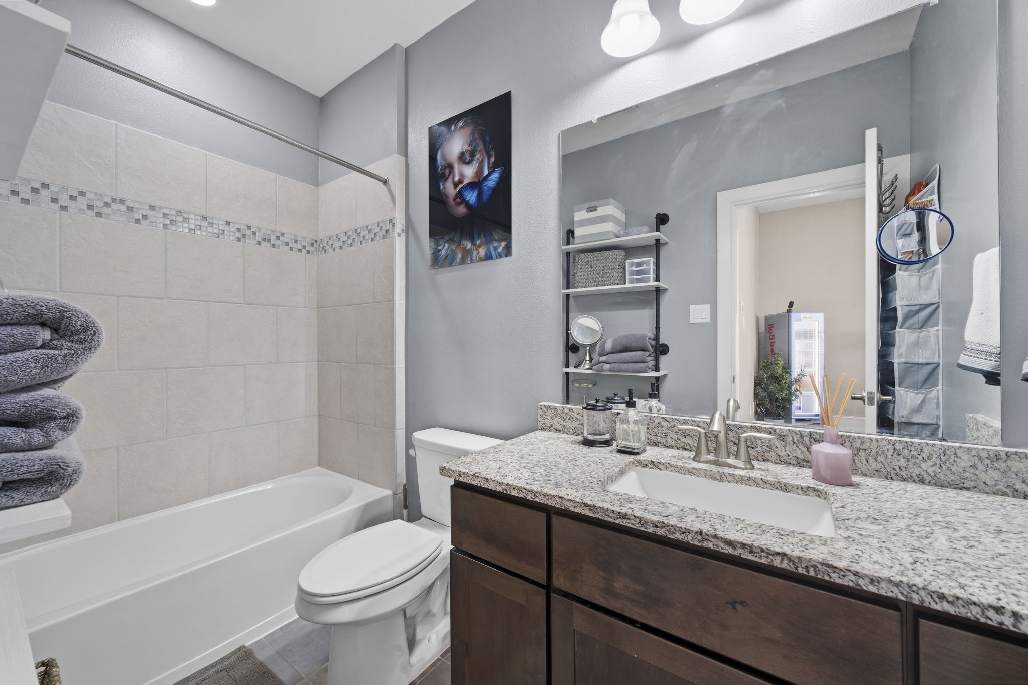 5467 Larkin Street Houston, TX 77007 - Photo 26 of 33 a bathroom with a granite countertop sink a toilet and a bathtub