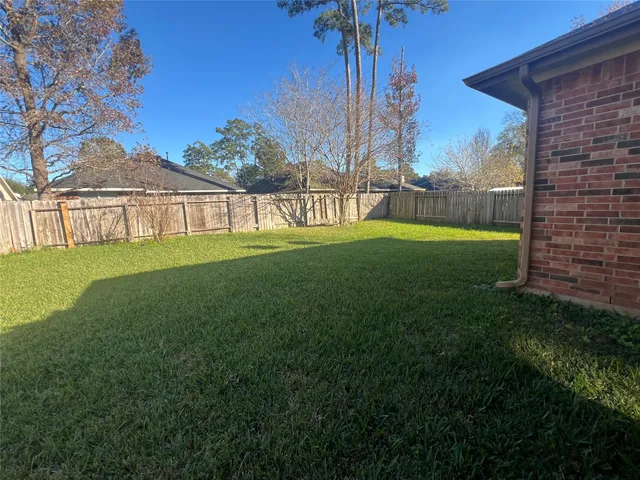 a view of big yard with a house in the background