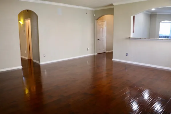 a view of a room with wooden floor and bathroom view