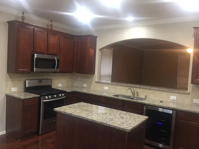 a kitchen with sink cabinets and microwave