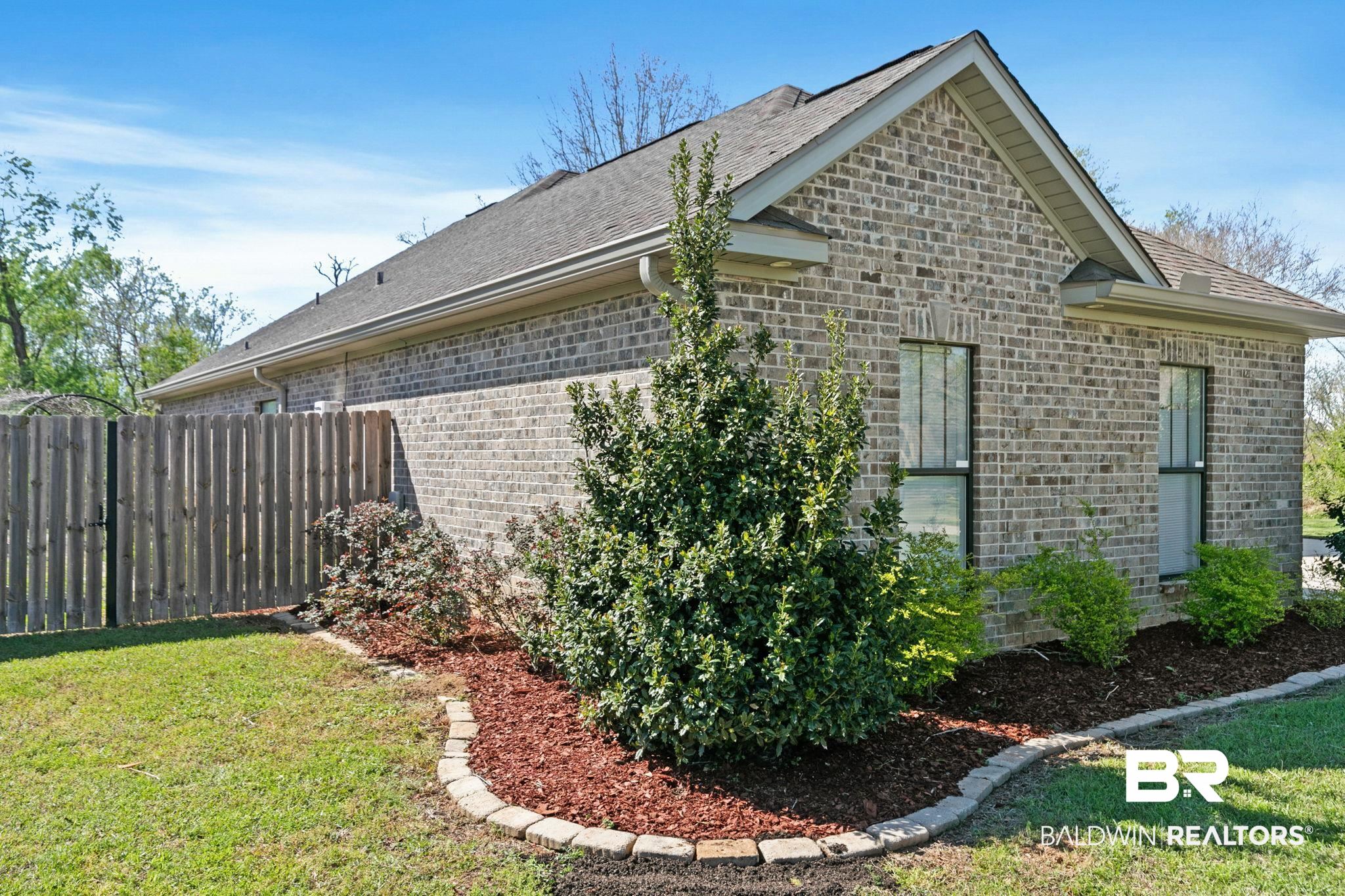 9584 Sanibel Loop Daphne, AL 36526 - Photo 6 of 48 View of home's exterior with brick siding and roof with shingles